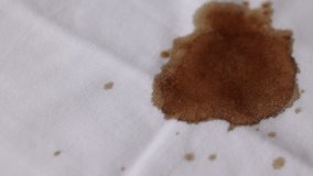 Coffee drop on the shirt. A white cotton shirt stained with brown coffee - Powered by Shutterstock - Get 15% off with code: PIKWIZARD15