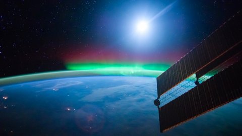 Time lapse view of Aurora Borealis and moon set over the Atlantic Ocean from the space in 4K