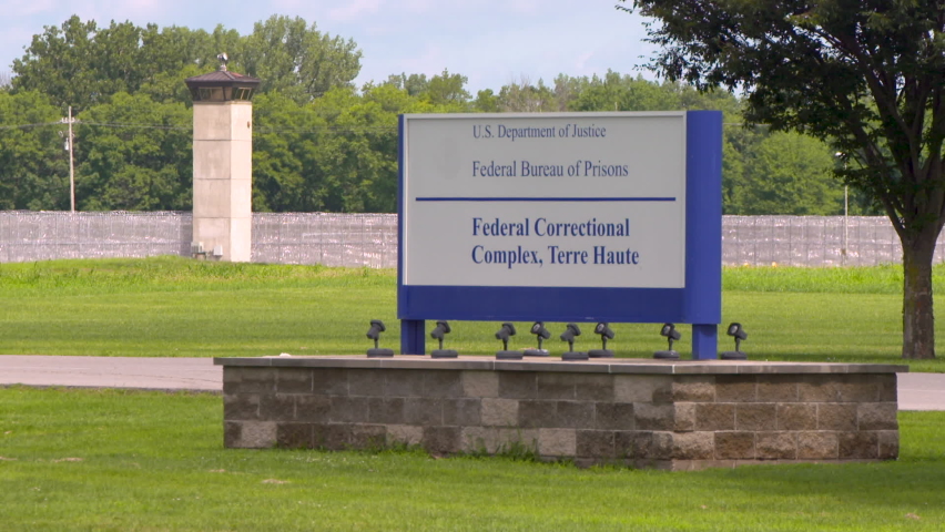Federal Bureau of Prisons sign in front barbed wire fence located in Terre Haute, Indiana.  16 death row inmates have been executed here includingTimothy McVeigh.