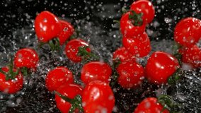 Super Slow Motion Shot of Cherry Tomatoes Flying into Water on Black Background at 1000fps. - Powered by Shutterstock - Get 15% off with code: PIKWIZARD15