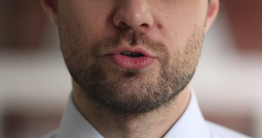 Extreme close up view moving mouth of businessman, face part of speaking male leader having influence to audience makes announcement, motivational speech, say text, provide helpful information concept | Shutterstock HD Video #1069355935