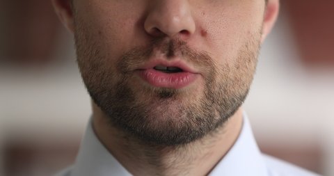 Extreme close up view moving mouth of businessman, face part of speaking male leader having influence to audience makes announcement, motivational speech, say text, provide helpful information concept