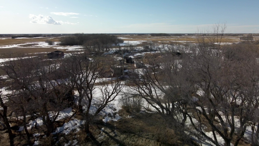 An aerial view of old dilapidated farming homesteads built by the original settlers of the prairie province of Saskatchewan, Canada. 