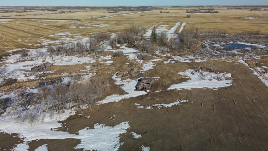 An aerial view of old dilapidated farming homesteads built by the original settlers of the prairie province of Saskatchewan, Canada. 