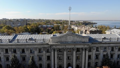 Aerial view of City Hall, an old building with columns, 4k video from a drone overlooking the city, rooftops, a river and a bridge, drone video cityscape, top view of bridghe and rooftops