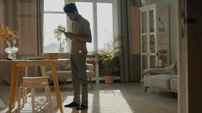 DX WIDE Full portrait of African American Black kid boy using his phone at home. Shot with 2x anamorphic lens