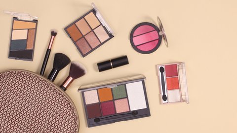 6k Make up beauty products appear from make up kit on nude background. Cosmetics flat lay stop motion