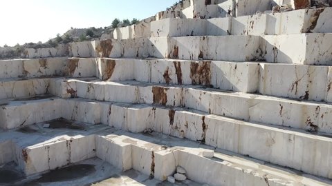 Marble quarry real time footage from above. Sledges of excavated marble stone material at Mediterranean region of Mersin, Turkey. Aerial view