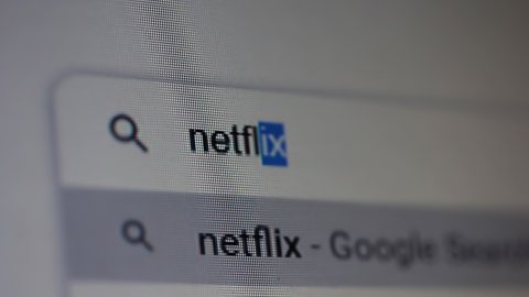 Buenos Aires, Argentina - March 2021: Searching for "Netflix" in an Internet Search Engine on a Computer. Close Up. 4K Resolution.