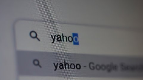 Buenos Aires, Argentina - March 2021: Searching for "Yahoo" in an Internet Search Engine on a Computer. Close Up. 4K Resolution.