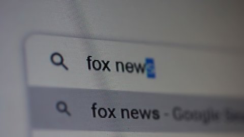 Buenos Aires, Argentina - March 2021: Searching for "Fox News" in an Internet Search Engine on a Computer. Close Up. 4K Resolution.
