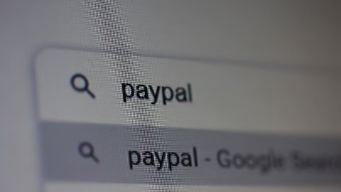 Buenos Aires, Argentina - March 2021: Searching for "Paypal" in an Internet Search Engine on a Computer. Close Up. 4K Resolution.
