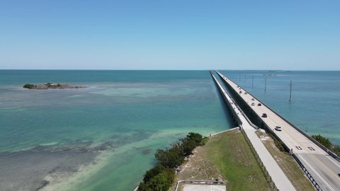 Drone flight north from Duck Key to the bridge near Little Money Key. Little Money Key is visible on the left side over the beautiful green ocean along US highway 1