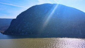 Aerial drone footage of the Appalachian mountains over a river valley in new york in the hudson river valley looking at storm king mountain in early spring