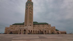 Timelapse of tourists walking infront of Hassan II Mosque in Casablanca