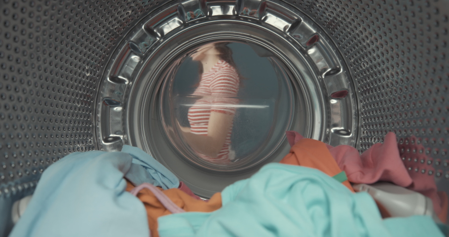 Shocked woman finds her smartphone in the washing machine after doing laundry, point of view shot | Shutterstock HD Video #1069393111