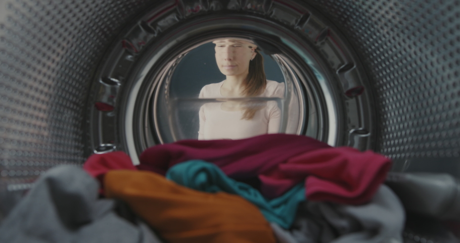 Happy woman removing clean fresh laundry from the washing machine, point of view shot | Shutterstock HD Video #1069393114