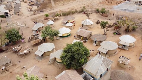 Aerial - a village in Sub-Saharan Africa, wide circle shot rising