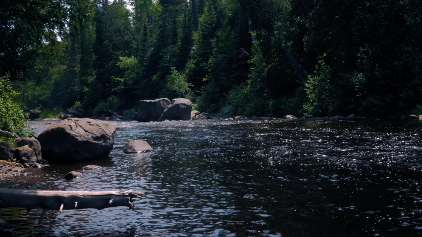 The Baptism River flowing through Tettegouche State Park Minnesota. The relaxing forest and calm flowing river.