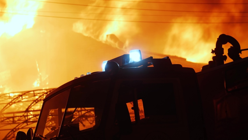 Fire truck and flasher fire engine. fire on the roof of the house. a burning at building house . home apartment insurance concept. huge fire blazes night houses 911. property damage arson protection | Shutterstock HD Video #1069423843