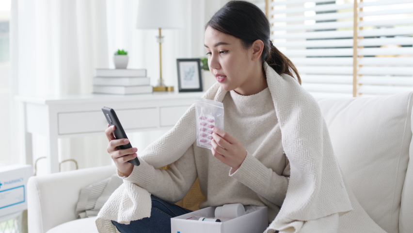 Young attractive beautiful asian female patient talk to doctor on cellphone videocall conference medical app in telehealth telemedicine online service hospital quarantine social distance at home. | Shutterstock HD Video #1069424047