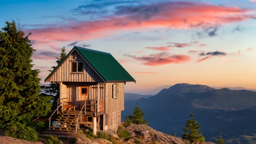 Cinemagraph Continuous Loop Animation. View of Tin Hat Cabin on top of a mountain. Dramatic Colorful Sunset Art Render. Located near Powell River, Sunshine Coast, British Columbia, Canada. Royalty-Free Stock Footage #1069431733