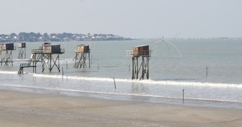 panoramic view of a fishing hut on stilts called Carrelet. beautiful french seaside. House of fishermen on stilts. typical carrelet fishing huts on a beach in Saint-Michel-Chef-Chef, Loire-Atlantique