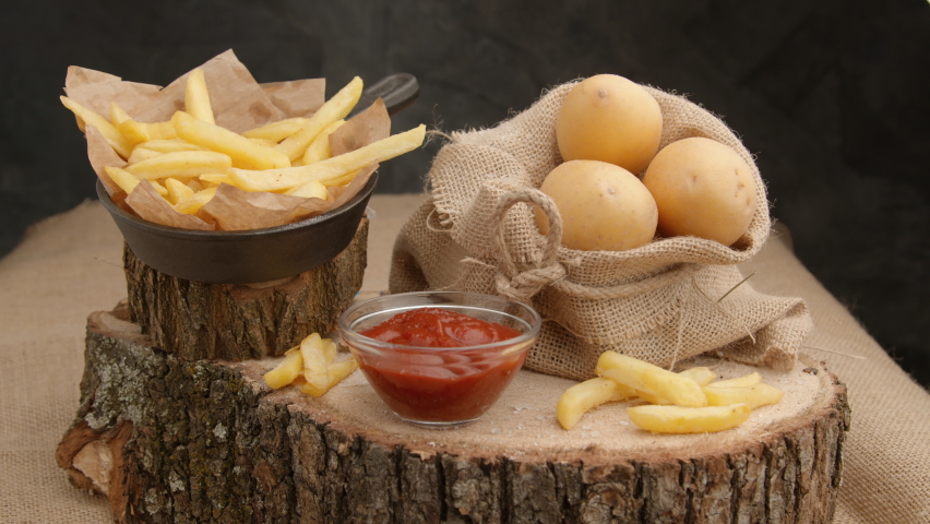 French Fries or Chips. Fast food restaurant, cooking potato, crispy fries, Junk food concept, top view Close up.  Royalty-Free Stock Footage #1069436365
