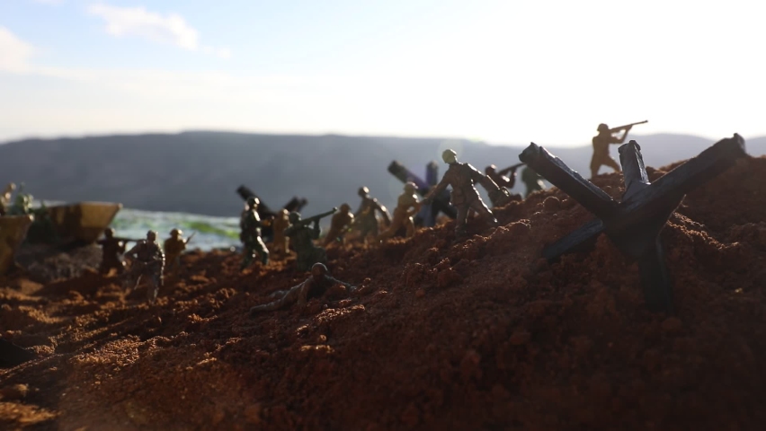 World War 2 reenactment (D-day). Creative decoration with toy soldiers, landing crafts and hedgehogs. Battle scene of Normandy landing on June 6, 1944. Selective focus