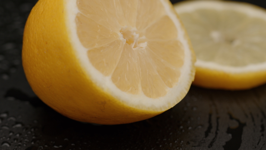 Lemon. Background.  close-up. Lemon close-up. Lemon macro. Lemon rotated. Macro shot of lemons, plenty of lemons, dramatic lightning, red epic, cut in half. Royalty-Free Stock Footage #1069436818