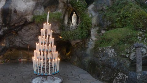 DOLLY SHOT - The Grotto of Massabielle is the place where the Virgin appeared to Bernadette Soubirous in 1858. At the back left of the Grotto is the Spring in Lourdes, France.