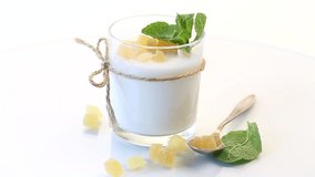 Sweet homemade yogurt with candied fruits in a glass