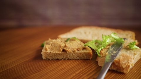 homemade meat pate with bread on a wooden table