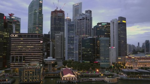 Drone Aerial Hyperlapse of Singapore CBD City Skyline during magic hour at Marina Bay - Singapore Nov 2020.