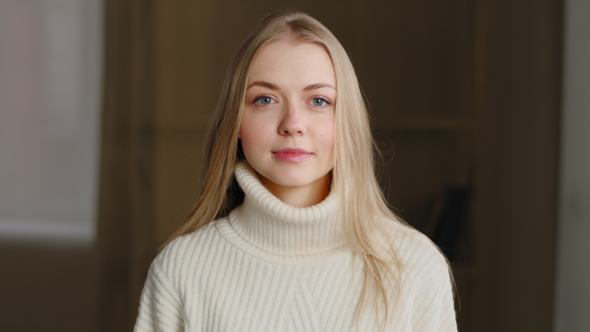 Portrait of successful beautiful caucasian millennial girl wearing white sweater, posing looking at camera, waving her head positively, answering yes. Close-up blonde woman nods approvingly, smiling Royalty-Free Stock Footage #1069448053