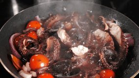 Boiling octopus in frying pan in kitchen. Top view. Cooking seafood dish at home or restaurant. Fresh Octopus And Veggies Cooking. Restaurant gourmet seafood dish preparation concept. 4 k video
