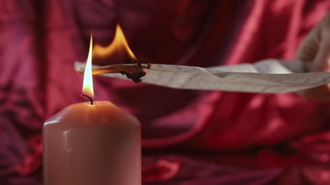 Burn letter with lit candle