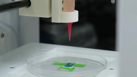3D bioprinter printing a biomaterial onto an electrode. 4k video.