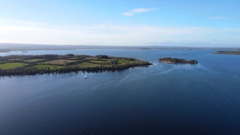Aerial panoramic view over Lough Derg on the River Shannon in Ireland. Clear sunny sky and green fields of a Illaunmore island in the background. Illaunmore is the largest island in the Lough Derg.