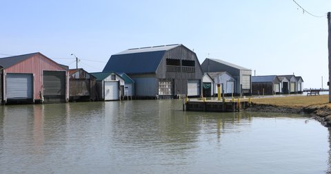 Scene of harbor and boathouses in Port Rowan, Ontario, Canada