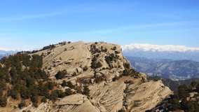Aerial view of big beautiful rocky mountains and surrounding mountains.
beautiful mountainous landscape.4K.Kahramanmaras Ali Kayası Turkey.
Snowy mountains appear on the horizon.