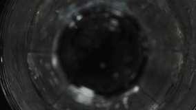 Ice cubes drop into tall clear glass and fill to top. Look down close up view of glass being filled with ice to prepare drink for service. Beverage preparation. - Powered by Shutterstock - Get 15% off with code: PIKWIZARD15