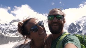 Slow motion: People taking selfies on a hike. Couple hiking taking cool video selfies 