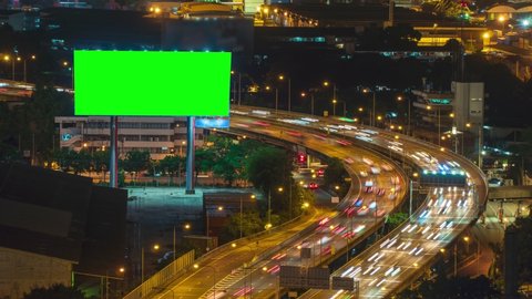 4K Time-lapse: Billboard green screen with city night traffic lights background. Bangkok Thailand. 4K Resolution. Top view of city traffic jams at night
