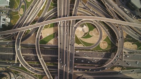 Aerial view of vehicles driving along Sheikh Zayed road with a complex and busy intersection right in Dubai downtown, United Arab Emirates.