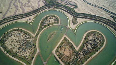 Aerial view of heart shaped artificial lake with Love written in the sand of Dubai desert, Dubai United Arab Emirates.