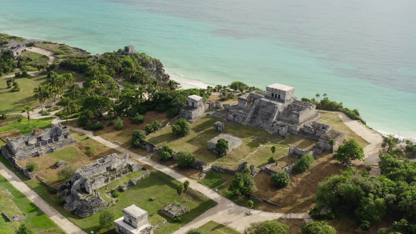 Drone video of the Mayan pyramids. Ancient buildings with temples stand on a rock by the sea in a beautiful landscape in the historic city of Tulum. Aerial view Cancun Mexico. | Shutterstock HD Video #1069487476