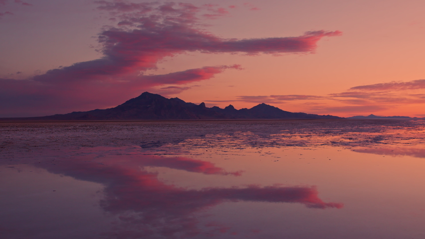 Timelapse of colorful sunrise over the Great Salt Lake as water covers the Bonneville Salt Flats in Utah.