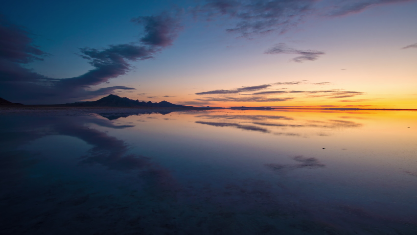 Colorful timelapse over the Great Salt Lake covering the Bonneville Salt Flats at sunrise in Utah.