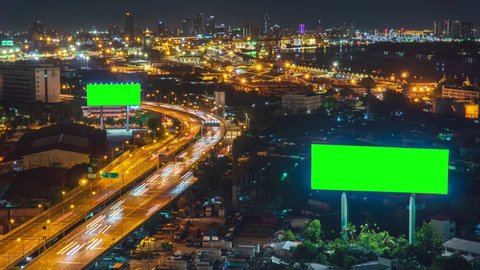 Time-lapse: Billboard green screen with city night traffic lights background. Bangkok Thailand. 4K Resolution. Top view of city traffic jams at night
